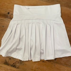 White tennis skirt with pleats and pocket in back. Size medium